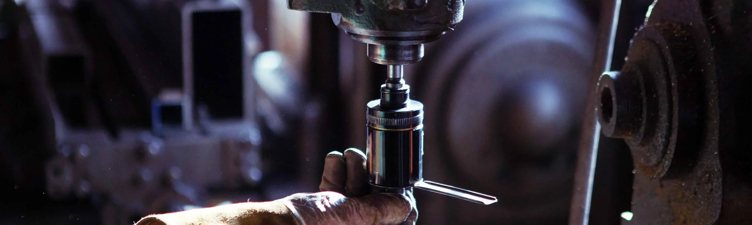 Worker using machine on metal