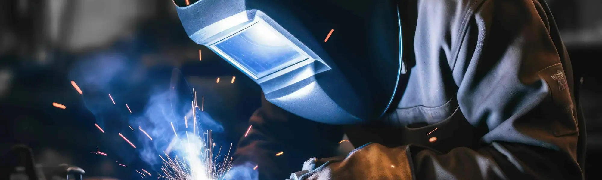 Welding professional welding metal with sparks in the dark