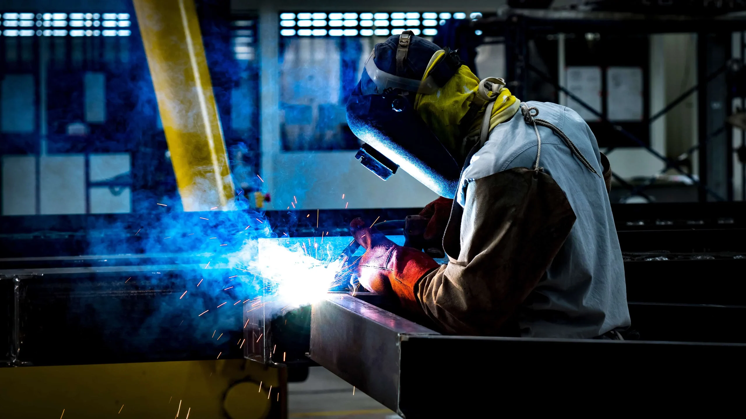 Welder welding steel with blue sparks