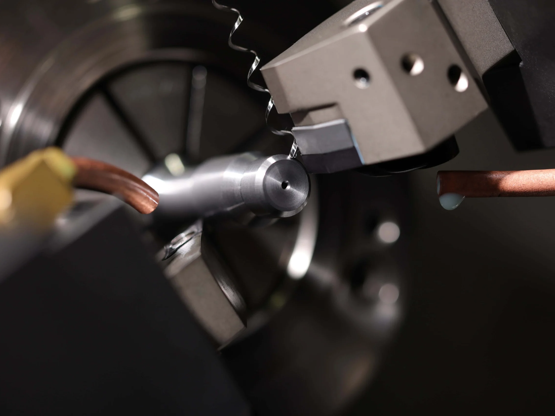 CNC turning machine cutting small metal part
